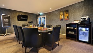 Boardroom for 10 guests with TV screen flip chart and drink facilities